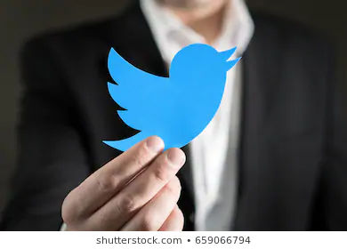 man holding twitter logo